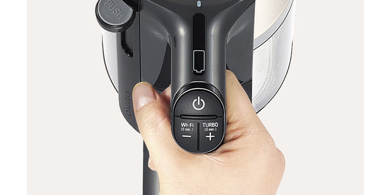 It shows the vacuum cleaner handle and the button on the handle.