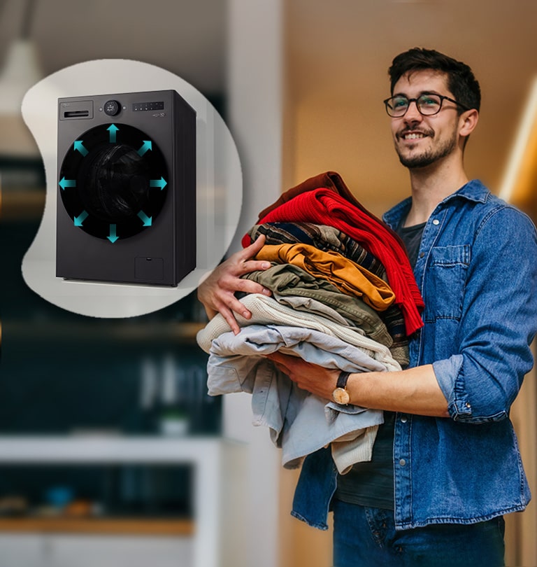 Man holds a stack of colourful clothes, with an LG washing machine displayed on the left.