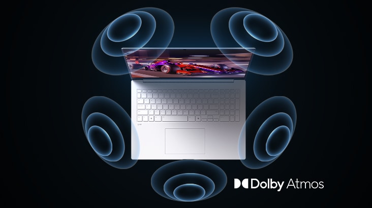 'The image shows a top-down view of a laptop with a vibrant, purple-themed graphic on the screen. Surrounding the laptop are dynamic sound wave visuals, indicating an immersive audio experience. The "Dolby Atmos" logo is displayed in the bottom right corner.