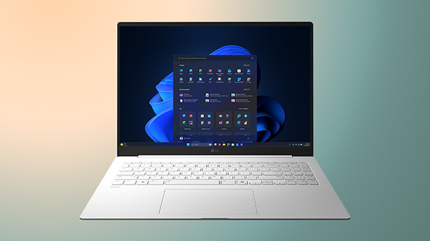 This image shows a laptop displaying a clear Windows 11 screen on a gradient background with a copy of "Upgrade your Efficiency."