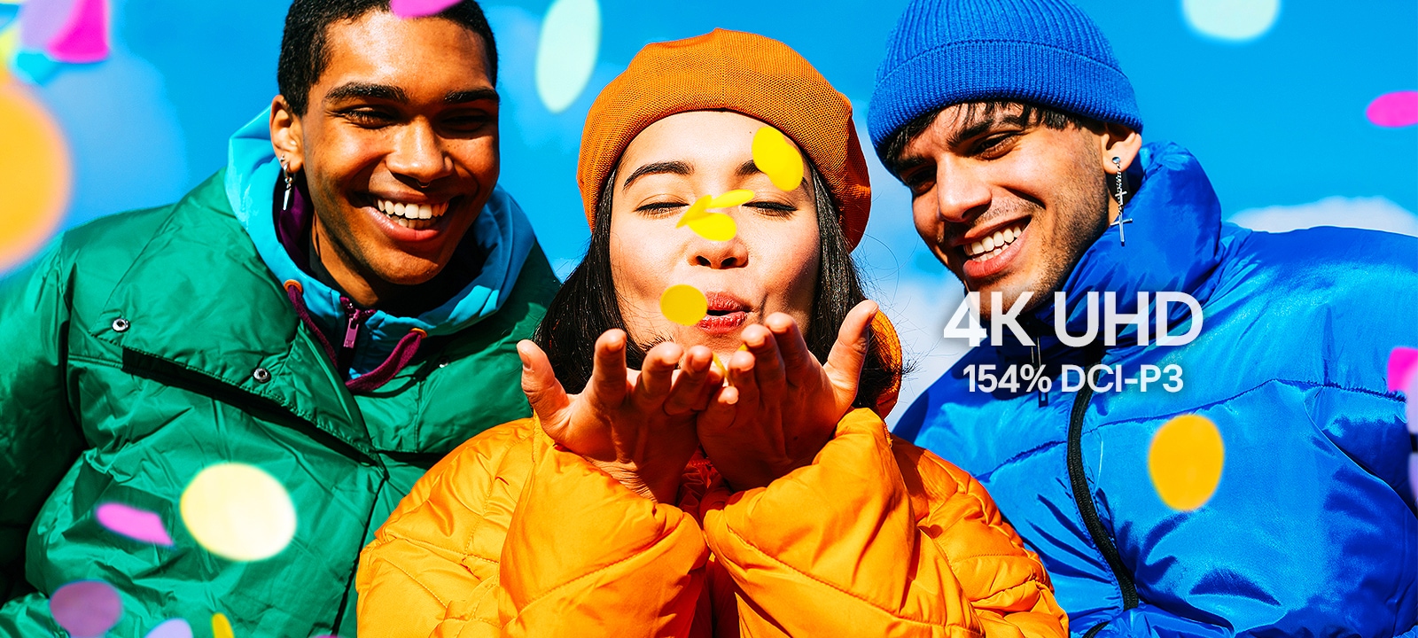 Three people wearing green, yellow, and blue outfits.
