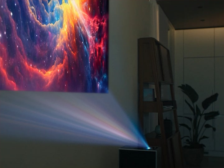 LG CineBeam projecting a galaxy image onto a wall. 