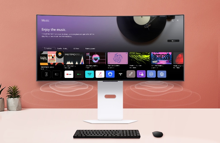 The smart monitor screen placed on the table displays the MUSIC APP screen.
