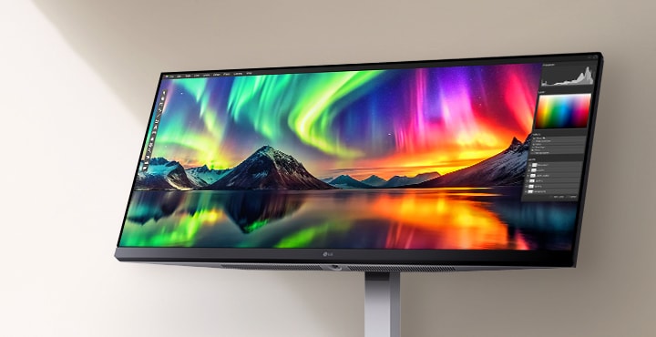 An ultra-wide LG monitor displaying vibrant aurora imagery with a photo editing interface, showcasing vivid color accuracy and high-resolution detail.