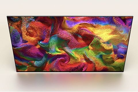 An angled aerial view of an LG QNED TV with an abstract, colorful artwork on screen.