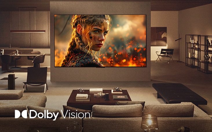 Woonkamer met een wall mounted LG TV. Op de tv wordt een film vertoond; de kleuren, helderheid en het contrast zijn ongelooflijk. We zien ook het Dolby Vision-logo.