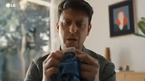 A man reading the tag on his pants, places them into the LG WashTower, and turns the dial to activate the Ai-Wash mode. A man reading the tag on his pants, places them into the LG WashTower, and turns the dial to activate the Ai-Wash mode.