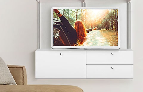 De LG room&TV past naadloos in elk interieur op een plank in de huiskamer, naast andere stijlvolle producten.