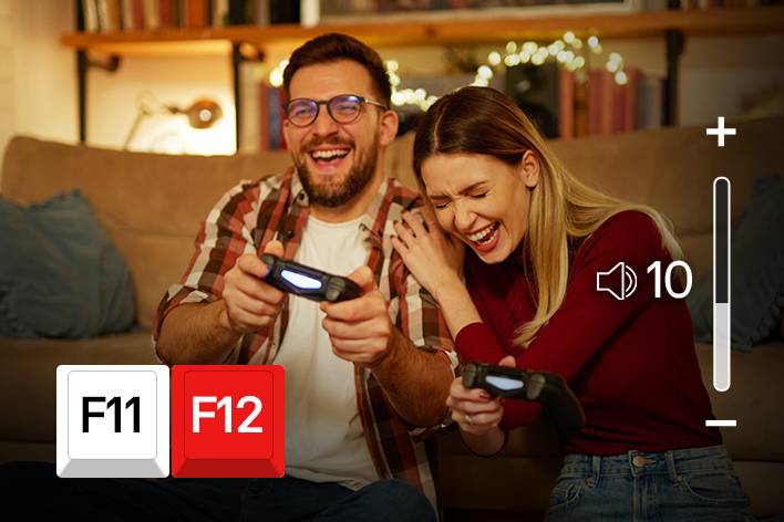 Acima da tela de cinema, os ícones de teclado F11 e F12 são exibidos e uma tela mostrando o aumento do volume está sendo reproduzida.