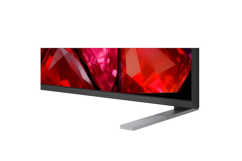A LG Mini RGB evo AI MRGB85 está instalada na parede de uma sala de estar ampla e contemporânea, exibindo uma obra de arte abstrata vibrante com elementos multicoloridos em espiral.