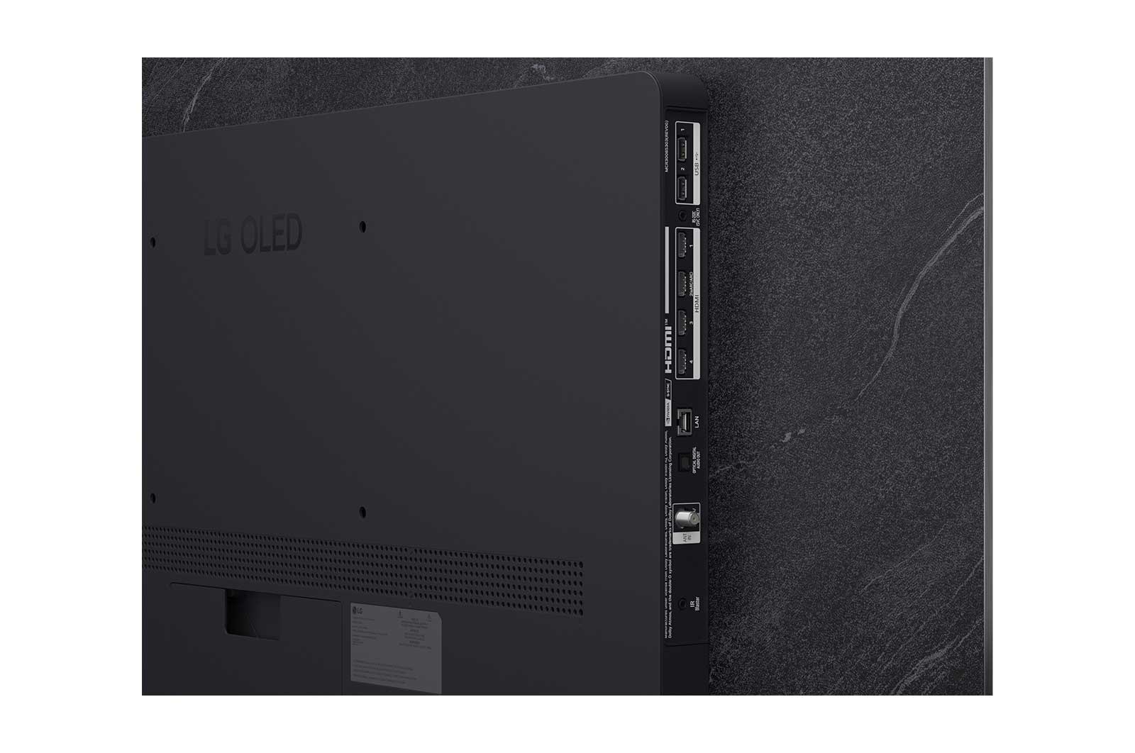 A LG OLED evo AI C6 está instalada na parede de uma sala de estar elegante, apresentando um design ultrafino com bordas estreitas, e exibe na tela uma paisagem urbana à beira do rio ao pôr do sol.