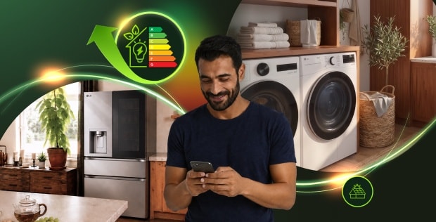 Man using a smartphone in a modern laundry room with LG washer, dryer and refrigerator, surrounded by glowing energy-efficiency graphics.