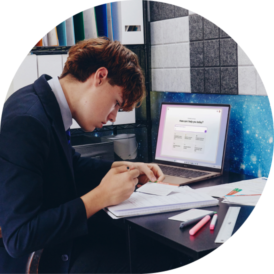 Student studying at a desk with an LG gram laptop in his bedroom.