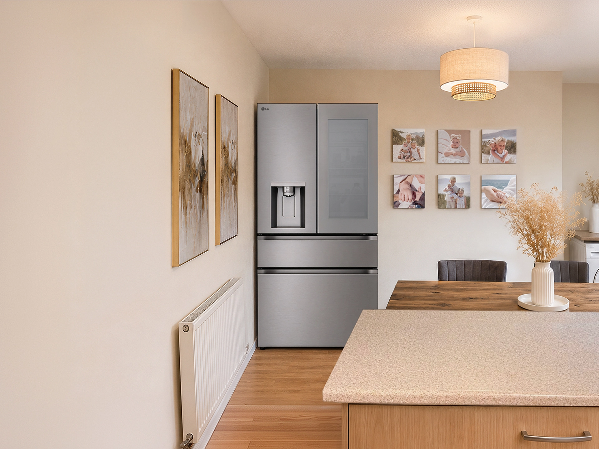 A stainless steel LG multi-door fridge freezer stands in a warm, modern dining room next to a wooden table and wall art.
