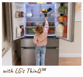 A toddler reaches inside an open, lit refrigerator. [with LG's ThinQ™]