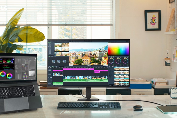 LG UHD 4K monitor feature highlights display a dynamic workspace featuring a laptop and monitor, perfect for video editing and creative projects with stunning visuals.