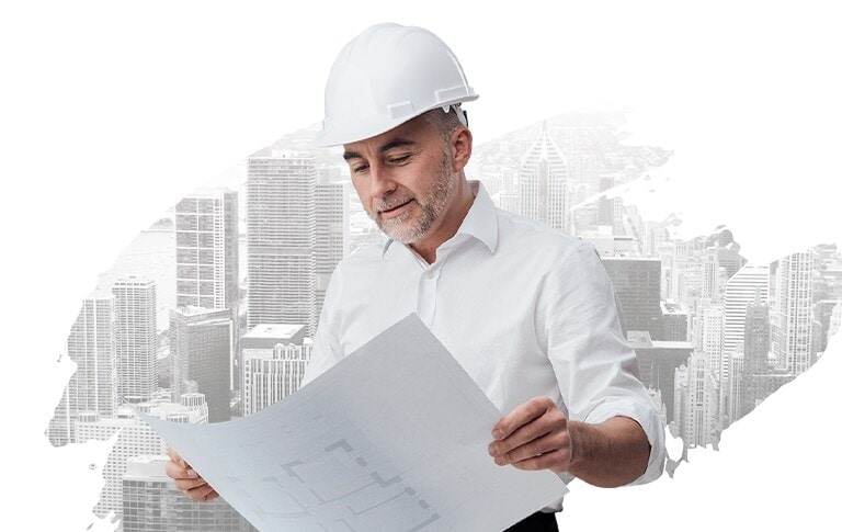 HVAC Consultant in a safety helmet looking at the blueprint.