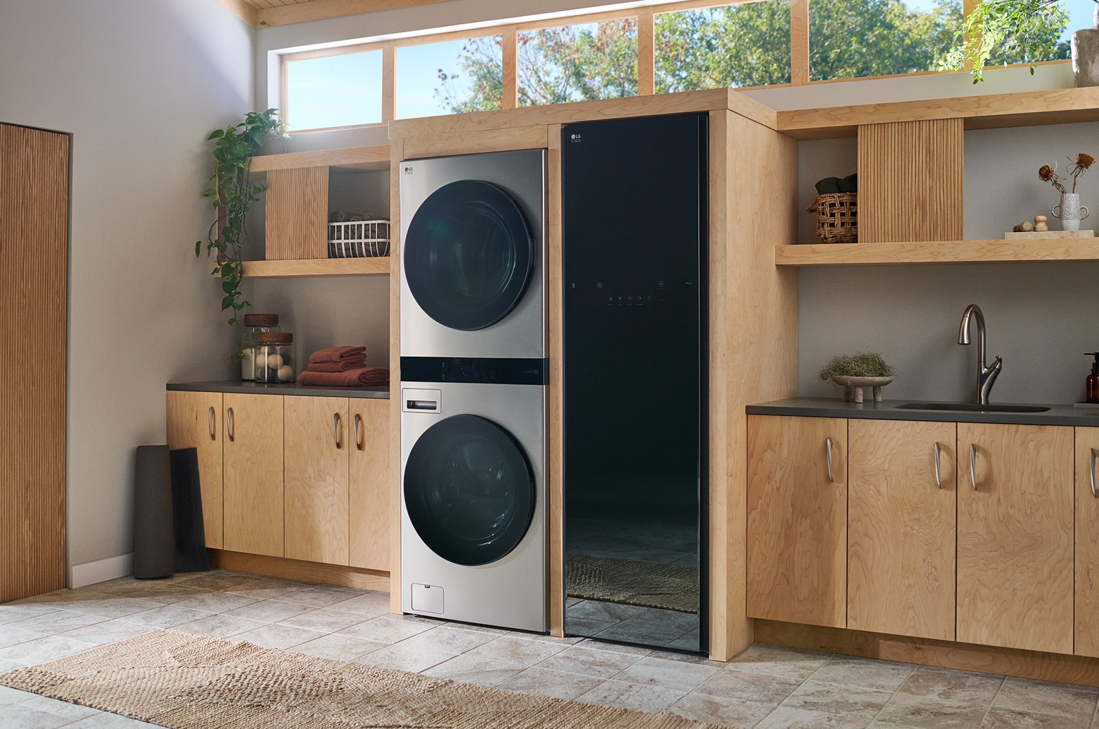 The LG WashTower SWWE50N3 in Stainless Steel, showcasing its sleek, single-unit design seamlessly integrated into a stylish, modern laundry room.
