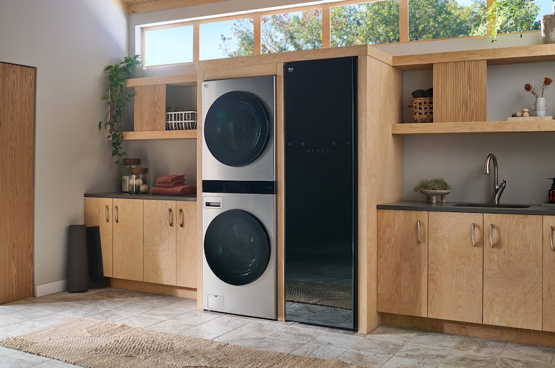The LG WashTower SWWE50N3 in Stainless Steel, showcasing its sleek, single-unit design seamlessly integrated into a stylish, modern laundry room.