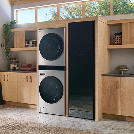 The LG WashTower SWWE50N3 in Stainless Steel, showcasing its sleek, single-unit design seamlessly integrated into a stylish, modern laundry room.