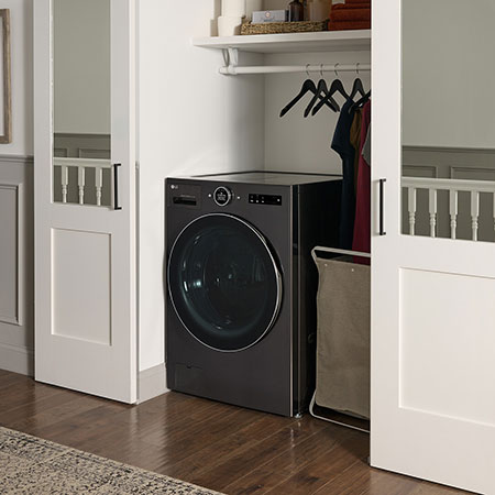 The LG Front Load Washer Dryer Combo WM6998HBA in Black Steel, showcasing its space-saving all-in-one design and discrete installation within a fitted closet.