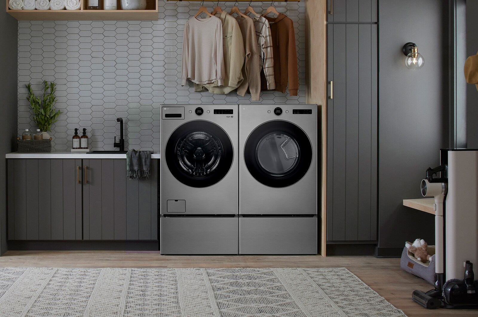 The Graphite Steel LG 7.4 cu.ft. dryer DLGX5501V, installed side-by-side with a matching washer on pedestals in a modern laundry room.