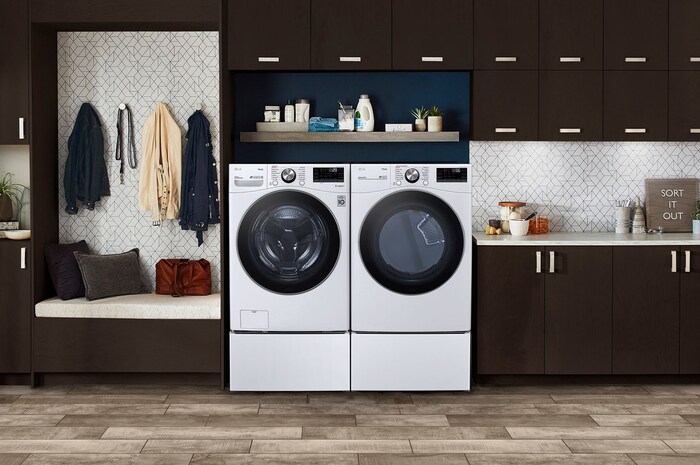 The LG Front Load Washer and Dryer set (DLEX4200W) in White, showcasing its classic aesthetic and seamless side-by-side integration on pedestals in a modern laundry room.