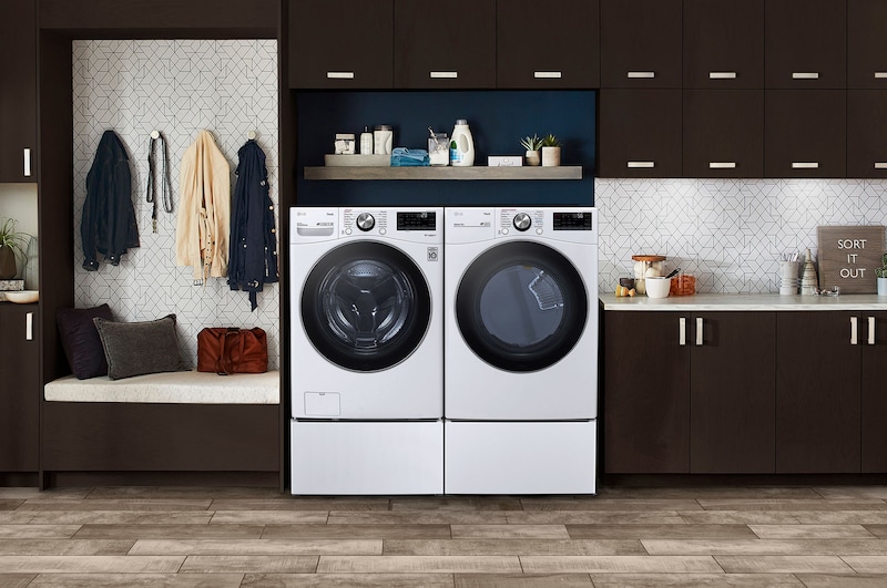 The LG Front Load Washer and Dryer set (DLEX4200W) in White, showcasing its classic aesthetic and seamless side-by-side integration on pedestals in a modern laundry room.