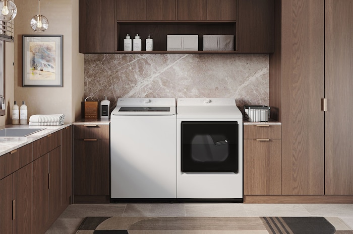 The LG Top Load Washer and Dryer set (DLE8200W) in White, showcasing the flat-top design and clean finish integrated perfectly beneath the upper cabinetry.
