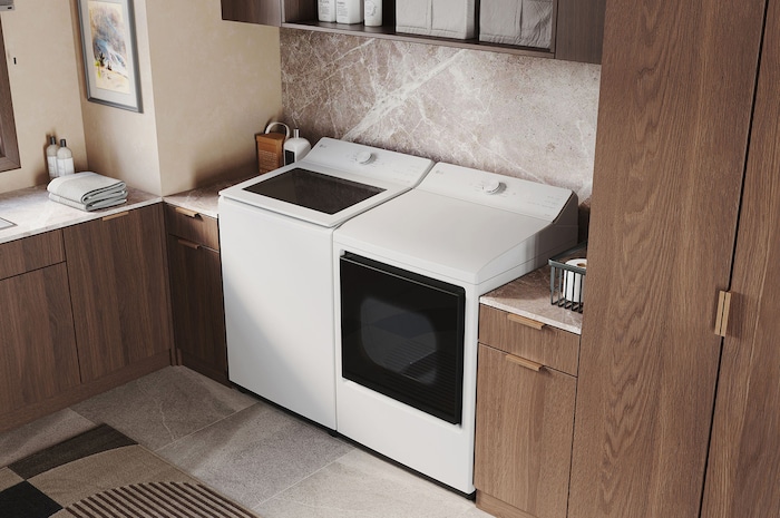 The LG Top Load Washer and Dryer set (DLE8200W) in White, showcasing its premium, side-by-side design seamlessly integrated into a luxurious laundry room with marble and wood finishes.