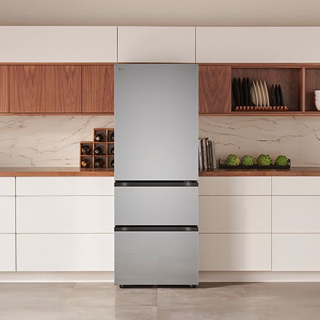 The stainless steel finish LG 26-inch 11.7 cu.ft. Kimchi Refrigerator LK12S6000V, shown installed in a modern kitchen.