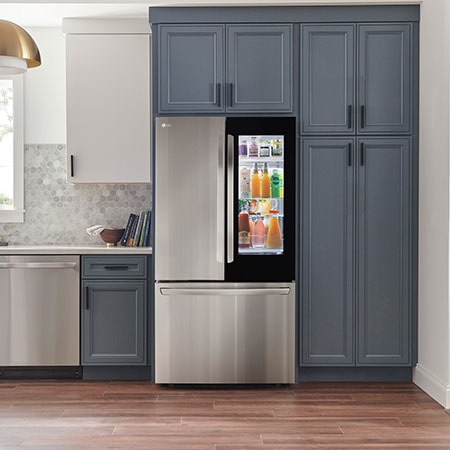 The PrintProof™ Stainless Steel LG 36-inch 27 cu.ft. French Door Refrigerator LRFGC2706S with InstaView™ Door-in-Door®, shown in a modern kitchen.
