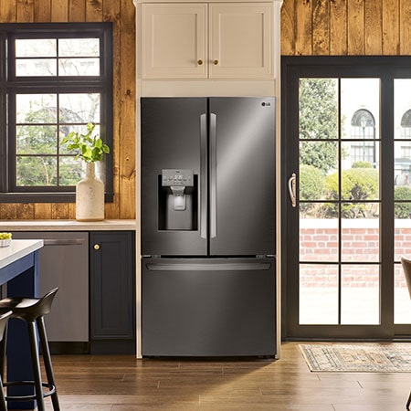 The PrintProof™ Black Stainless Steel LG 36-inch 28 cu.ft. French Door Refrigerator LRFS28XBD with water dispenser, shown installed in a warm-toned kitchen.