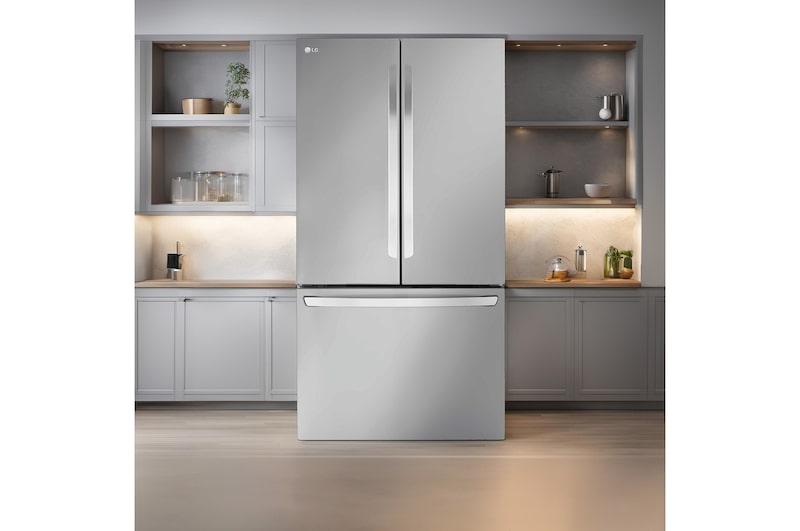 LG French Door Fridge Freezer LRFLS3206S in Prime Stainless Steel, elegantly integrated into a modern kitchen with grey cabinetry and warm ambient lighting.