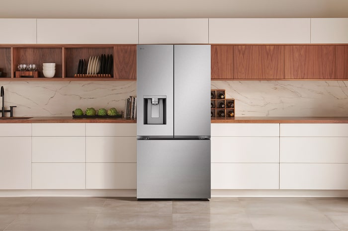 The PrintProof™ Stainless Steel LG 33-inch 25 cu.ft. French Door Refrigerator LF25S6330S with ice & water dispenser, shown in a modern kitchen.