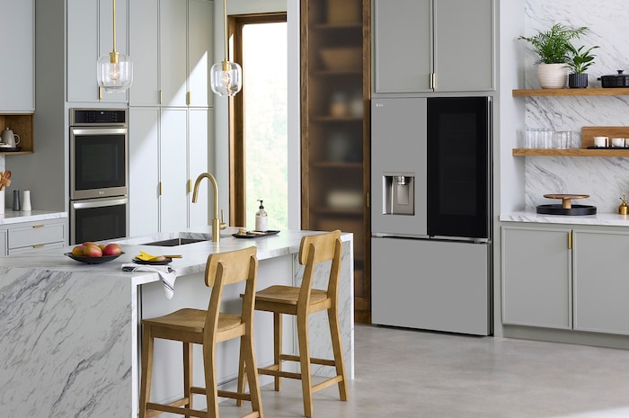 The PrintProof™ Stainless Steel LG 36-inch 26 cu.ft. French Door Refrigerator LF26C6360S with InstaView® Door-in-Door®, shown in a bright modern kitchen.