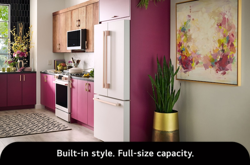 The LG STUDIO SRFB27W3 refrigerator in white with bronze handles, highlighting its Counter-Depth MAX™ design offering a built-in look with 27 cu.ft. capacity.