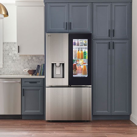 The PrintProof™ Stainless Steel LG 36-inch 31 cu.ft. French Door Refrigerator LF31S6360S with illuminated InstaView® Door-in-Door® and ice & water dispenser, in a modern kitchen.