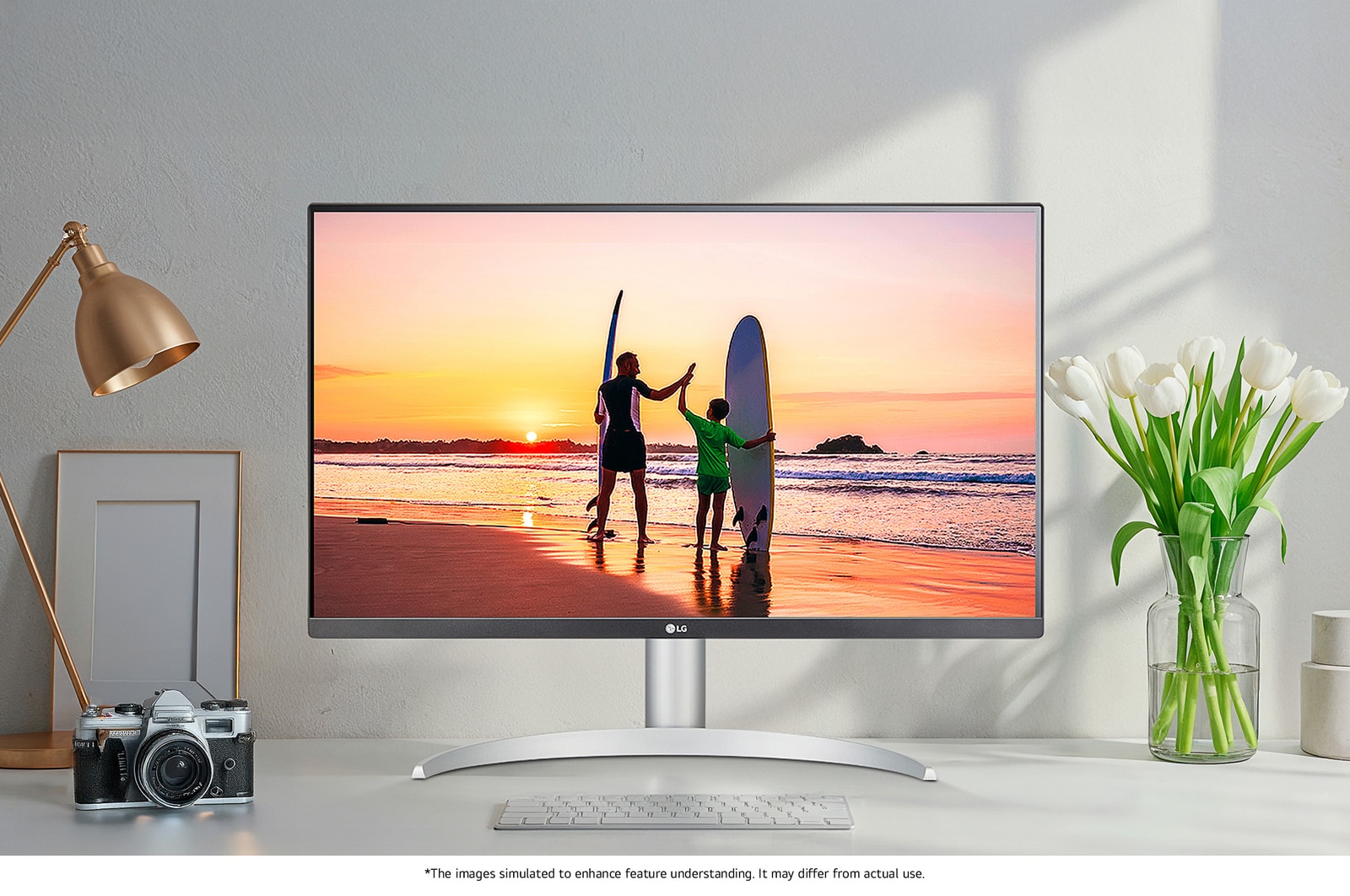 LG Monitor 27UP650K in a white/silver design positioned on a desk, displaying a vibrant, high-resolution image of a beach sunset and highlighting the superb picture quality.