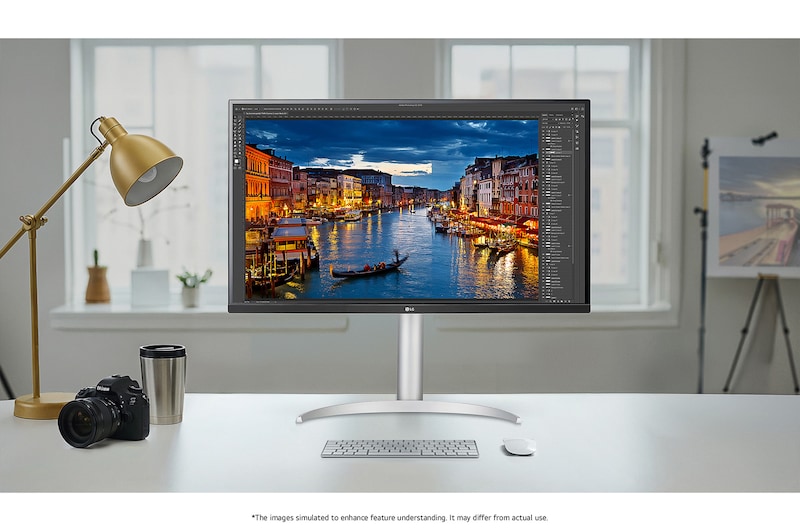 The LG Monitor 32UP83AK in a silver/black finish, featuring 4K UHD resolution and precise colour representation, is shown handling professional photo editing in a bright studio setting.