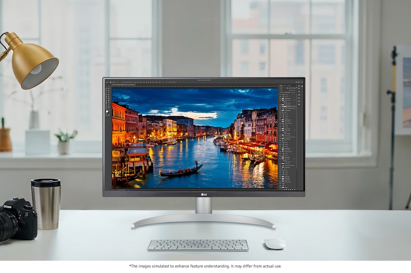 LG Monitor 27UP850K in a white/silver design positioned on a bright desk setup, displaying photo editing software and highlighting the precise and clear 4K picture quality.