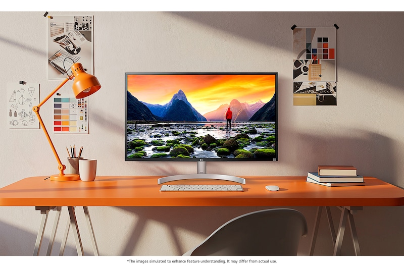 The LG UltraFine™ Monitor 32UL500 in Black/Silver is integrated into a bright, creative workspace, displaying stunning landscape details.