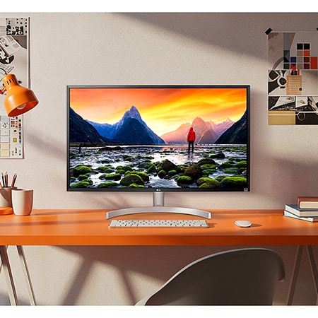 The LG UltraFine™ Monitor 32UL500 in Black/Silver is integrated into a bright, creative workspace, displaying stunning landscape details.