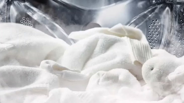 Image of white blaket in a machine with steam showing Image of white blaket in a machine with steam showing