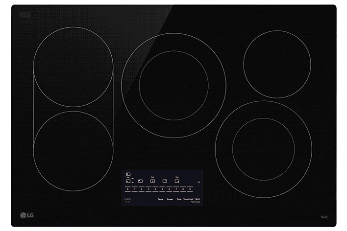 Close-up of a black glass electric cooktop featuring a dual-ring heating element glowing red.