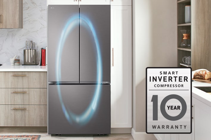 Stainless steel French door refrigerator in a kitchen with a 10-year smart inverter compressor warranty badge.