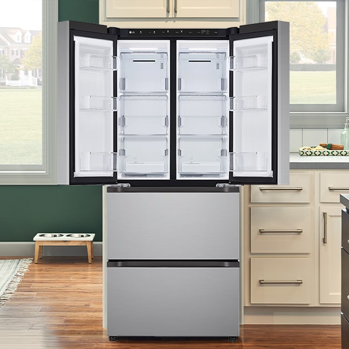 Stainless steel French door refrigerator with open top doors showing a bright interior with multiple shelves and bins.