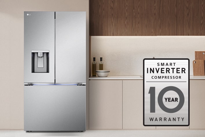 Close-up of an LG Smart Inverter Compressor inside a stainless steel refrigerator with a 10-year warranty logo.