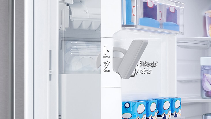 Close-up of a Slim Spaceplus Ice System inside a white refrigerator door with an open/close latch mechanism.