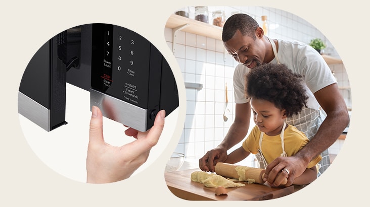 A person opening a black microwave next to a father and child baking together in a kitchen.